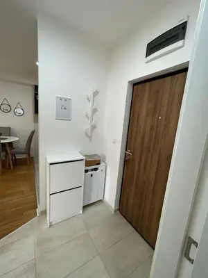 a room with a door and a kitchen and a table at Delete 44 in Novi Grad