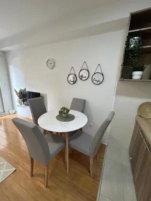 a dining room with a white table and chairs at Delete 44 in Novi Grad