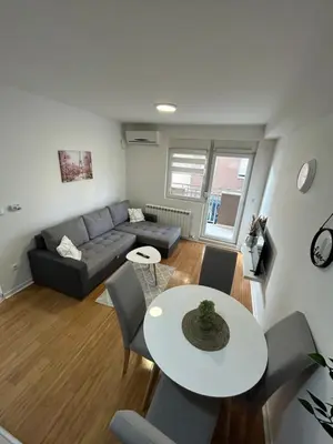 a living room with a couch and a table at Delete 44 in Novi Grad