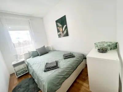 a small bedroom with a bed in a room at GreenCity10 in Belgrade