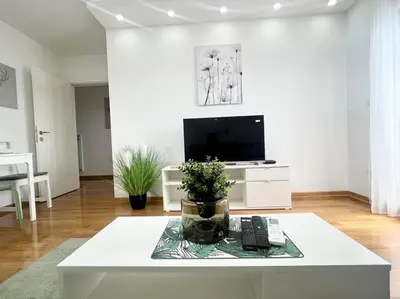 a living room with a coffee table and a tv at GreenCity10 in Belgrade