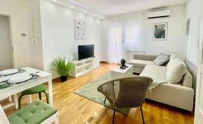 a living room with a couch and a table at GreenCity10 in Belgrade