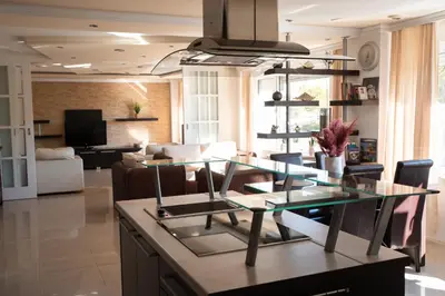 a living room with a glass table and chairs at Sweet House Parlament Lux in Belgrade