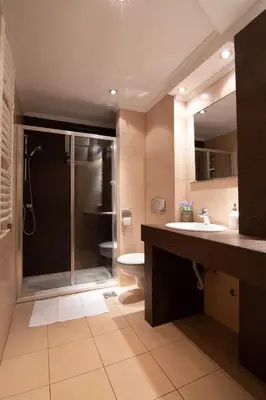 a bathroom with a shower and a toilet and a sink at Sweet House Parlament Lux in Belgrade