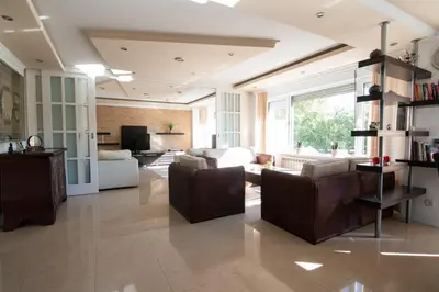 a large living room with a couch and chairs at Sweet House Parlament Lux in Belgrade