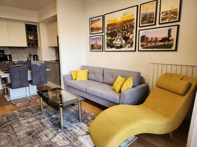 a living room with a couch and a table at Ramonda Belgrade Waterfront - BW Aqua in Belgrade
