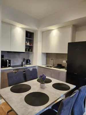 a kitchen with a table with purple flowers on it at Ramonda Belgrade Waterfront - BW Aqua in Belgrade