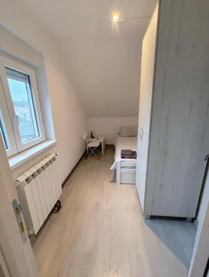 a room with a hallway with a table and a window at Privatna soba Marijana-Olja in Surčin