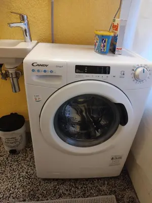 a washing machine in a bathroom next to a sink at BGholik studio apartment in Belgrade
