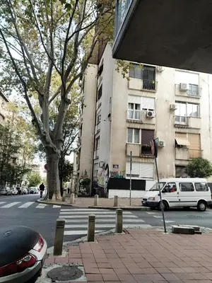 a city street with cars parked in front of a building at BGholik studio apartment in Belgrade