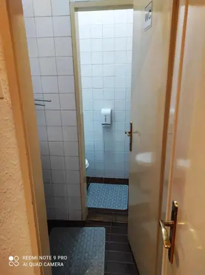 a bathroom with a shower with a blue tile floor at Fair and Share Apt 1-7 guests in Belgrade