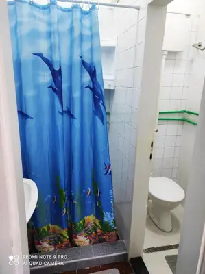 a bathroom with a shower curtain with a fish at Fair and Share Apt 1-7 guests in Belgrade