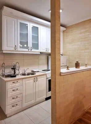 a kitchen with white cabinets and white appliances at Antik Apartman in Stara Pazova