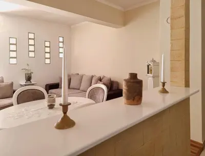 a living room with a table with candles on it at Antik Apartman in Stara Pazova