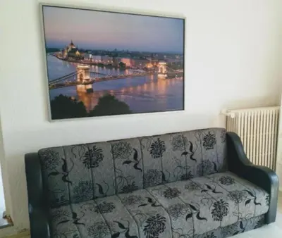 a couch in a living room with a picture of a bridge at Belgrade River view 1 in Belgrade