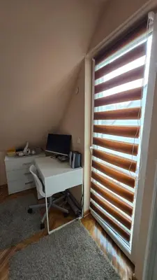 a room with a desk with a computer and a window at Cozy loft in Belgrade
