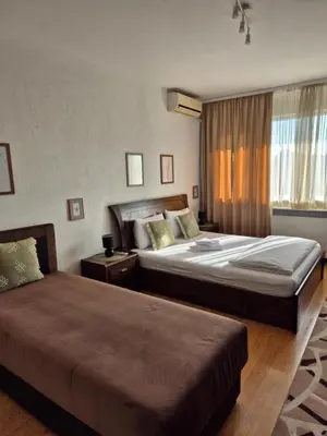 a hotel room with two beds and a window at Sweet House Parlament in Belgrade
