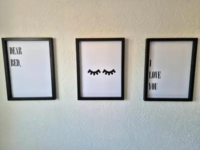 three framed pictures on a wall with the words i love you at Sweet House Parlament in Belgrade