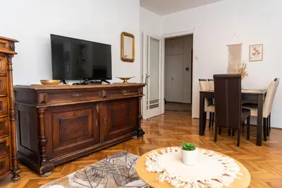 a living room with a television and a table at Sweet House Parlament in Belgrade