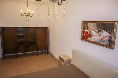 a living room with a painting on the wall at Audrey apartment Belgrade in Belgrade