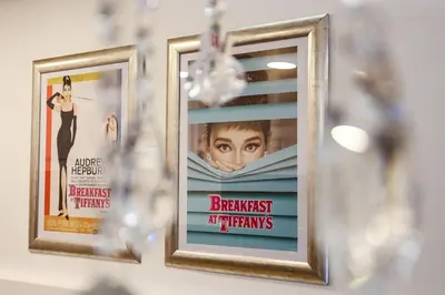 two framed pictures of a movie hanging on a wall at Audrey apartment Belgrade in Belgrade