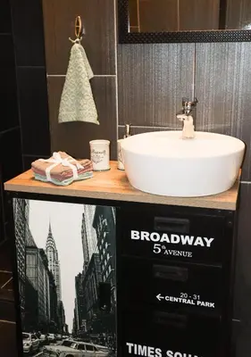 a bathroom with a sink and a sign for the brooklyn sixpence at Audrey apartment Belgrade in Belgrade