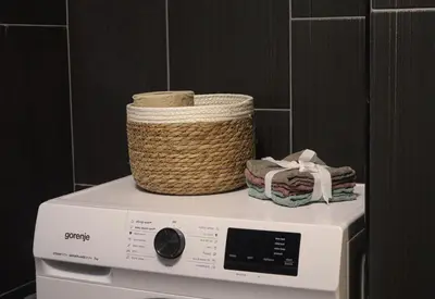 a basket on top of a washing machine at Audrey apartment Belgrade in Belgrade