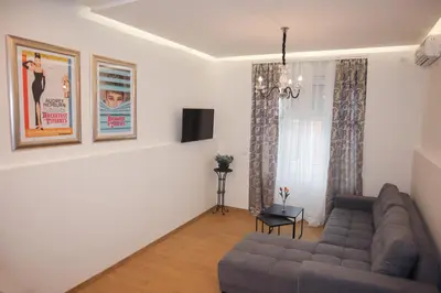 a living room with a couch and a tv at Audrey apartment Belgrade in Belgrade