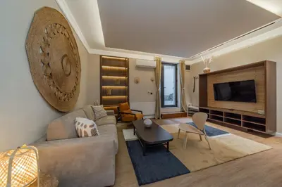 a living room with a couch and a television at Passpartu Apartments in Belgrade