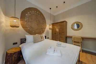 a bedroom with a large bed with two towels on it at Passpartu Apartments in Belgrade