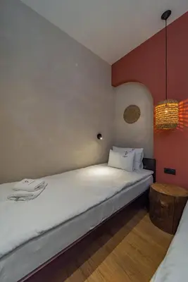 a bedroom with a large white bed and red walls at Passpartu Apartments in Belgrade