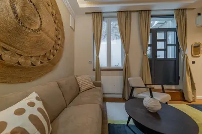 a living room with a couch and a table at Passpartu Apartments in Belgrade