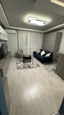 a living room with a couch and a table at Apartman Film City in Žarkovo
