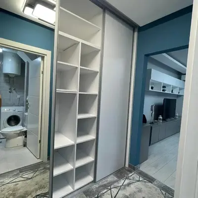 a walk in closet with a mirror in a room at Apartman Film City in Žarkovo