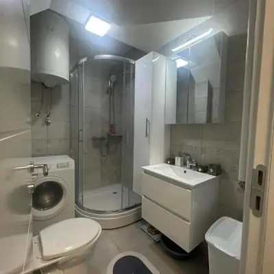 a bathroom with a shower and a toilet and a sink at Apartman Film City in Žarkovo