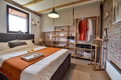 a bedroom with a bed and a brick wall at Top - kuća za odmor in Bukovik