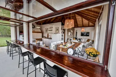 a large kitchen and dining room with a bar at Top - kuća za odmor in Bukovik