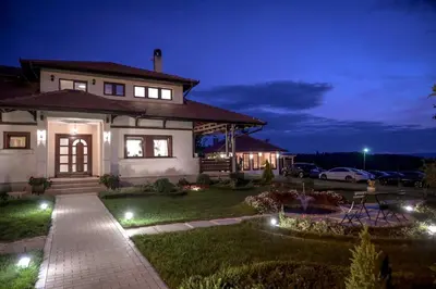 a house with lights in the yard at night at Top - kuća za odmor in Bukovik