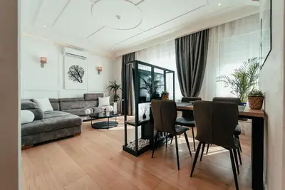 a living room with a table and a couch at Biarritz Luxury Apartments in Belgrade