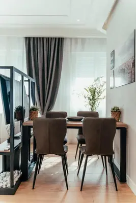 a dining room with a table and chairs at Biarritz Luxury Apartments in Belgrade