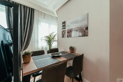 a dining room with a table and chairs at Biarritz Luxury Apartments in Belgrade