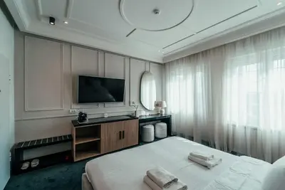 a hotel room with a bed and a television at Biarritz Luxury Apartments in Belgrade