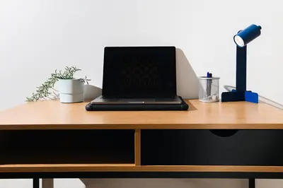 a laptop computer sitting on top of a wooden desk at Family Penthouse with Terrace 5min to Kalemegdan in Belgrade