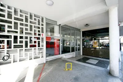 a store with a yellow stool in front of a building at Apartman Premijer 1 in Čukarica
