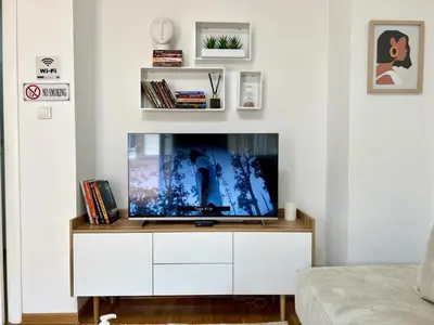 a living room with a flat screen tv on a white cabinet at BeoCity 011 in Novi Beograd