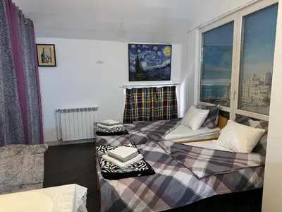 a room with two beds and a window at Zvezdana noc in Zvezdara