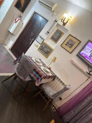 a living room with a table and a chair at Zvezdana noc in Zvezdara