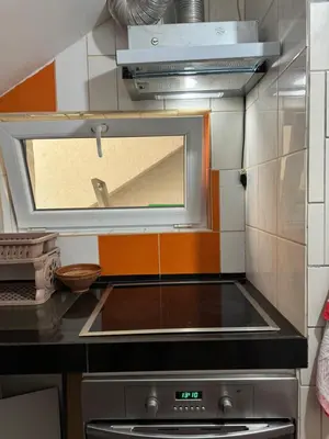 a kitchen with a window above a stove at Zvezdana noc in Zvezdara