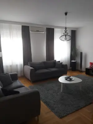 a living room with a couch and a table at Sky lux apartment Vracar in Belgrade