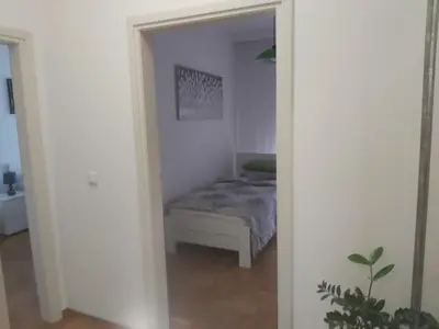 a bedroom with a bed in a white room at Sky lux apartment Vracar in Belgrade